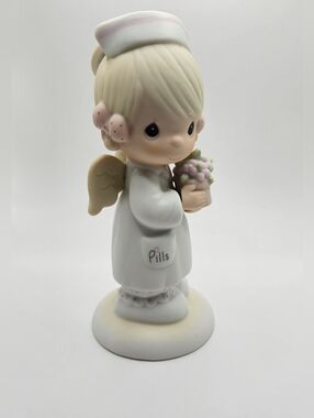Precious Moments white and Cream Angel of Mercy Figurine